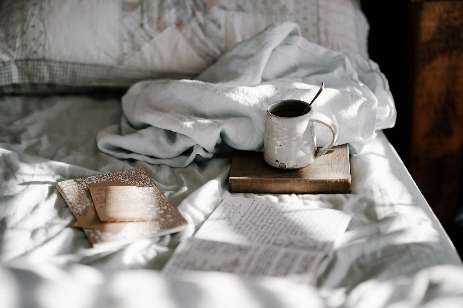 Bed with journal and tea insomnia