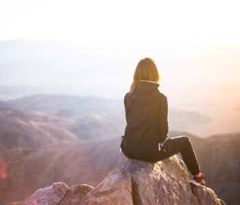 Woman sitting on rock help Anxiety Stress Burnout