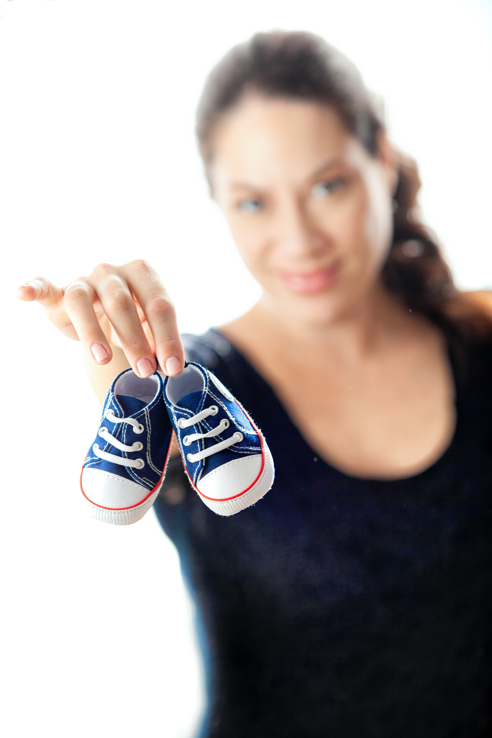 Woman holding baby shoes