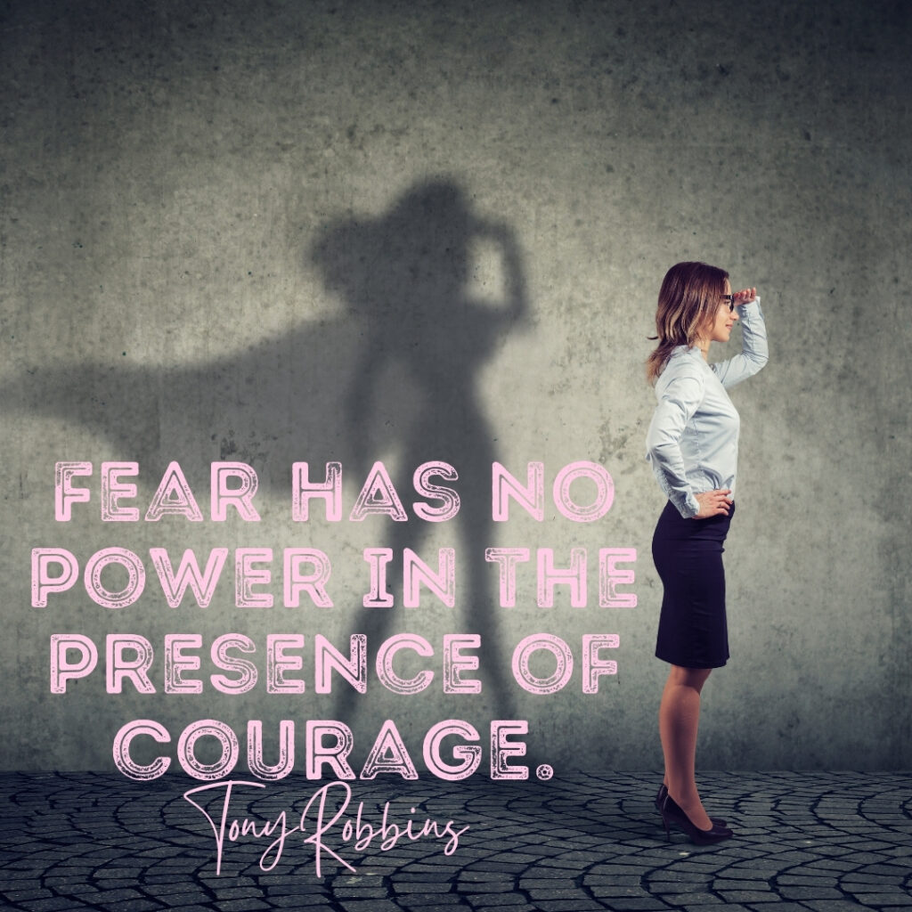 Quote by Tony Robbins: Fear has no power in the presence of courage. Picture of woman in business attire with superwoman shadow